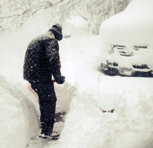 Steven Gros shovels snow from outside his home in Orchard Park
